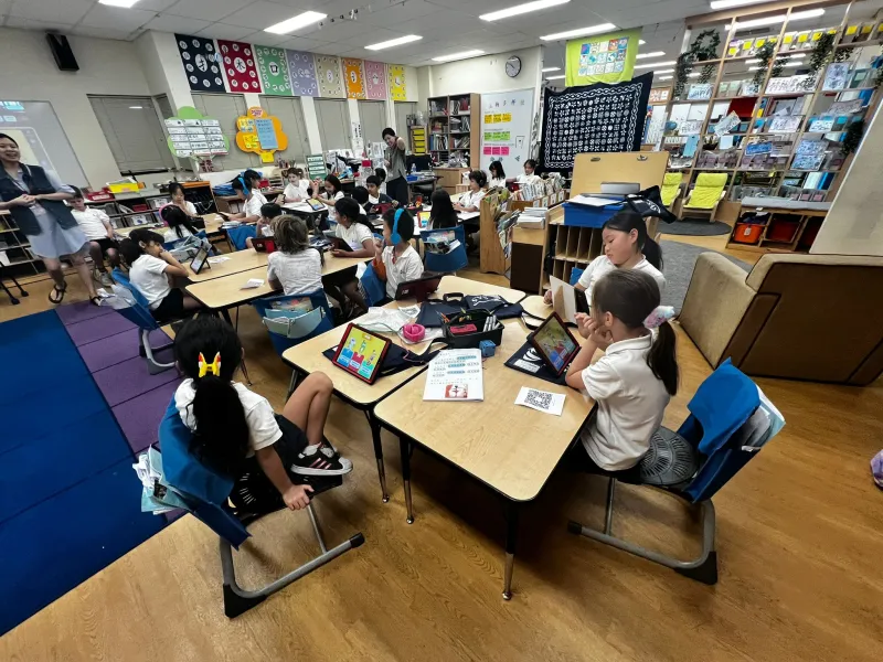 Students using Turtle Learn on tablets in classroom